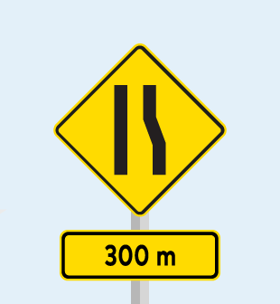 Yellow sign showing passing lane closing ahead sign in 300m